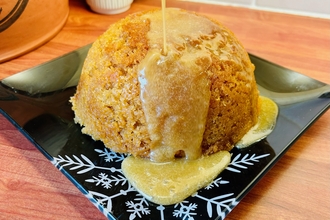 A steamed sponge pudding on a plate