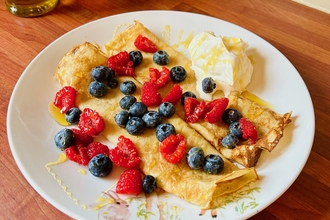 A plate of crepes and berries