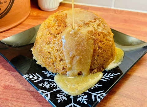 A steamed sponge pudding on a plate