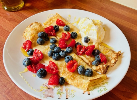 A plate of crepes and berries