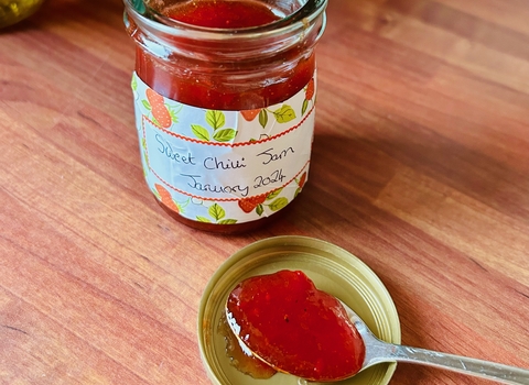 A jar of jam and a spoon